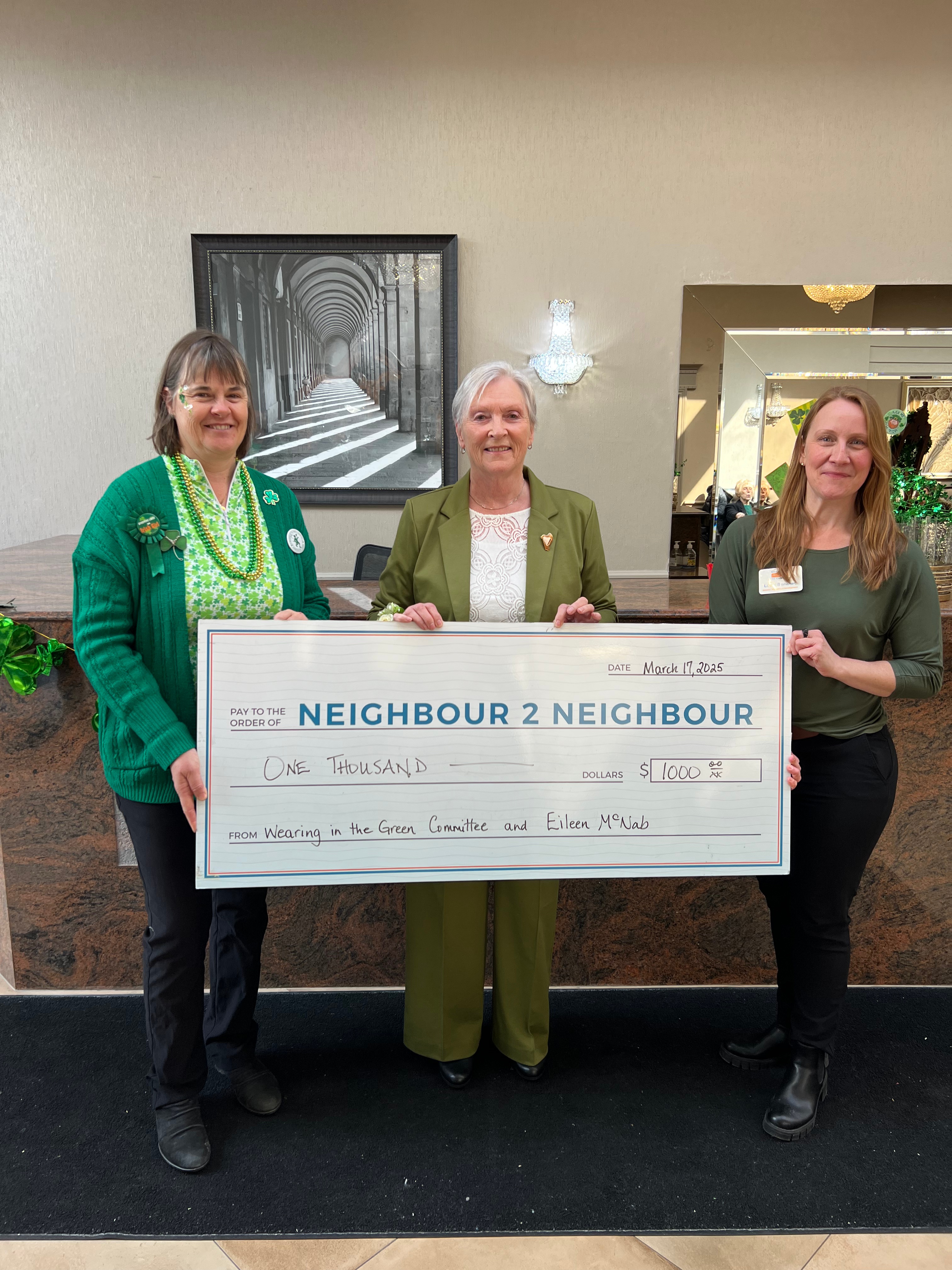Eileen presenting cheque to Neighbour to Neighbour