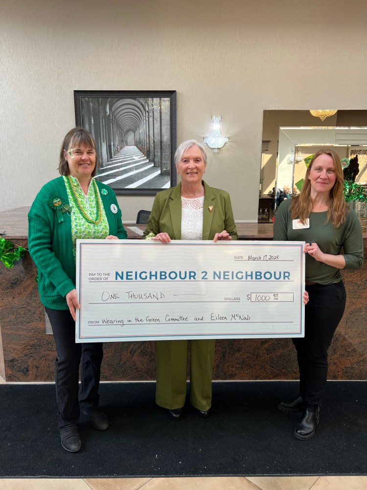 Eileen presenting cheque to Neighbour to Neighbour